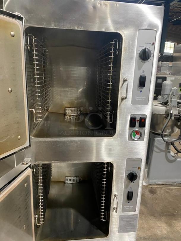 Commercial stainless steel double convection oven with dual doors open. Features control knobs and temperature gauge. Slight wear visible.