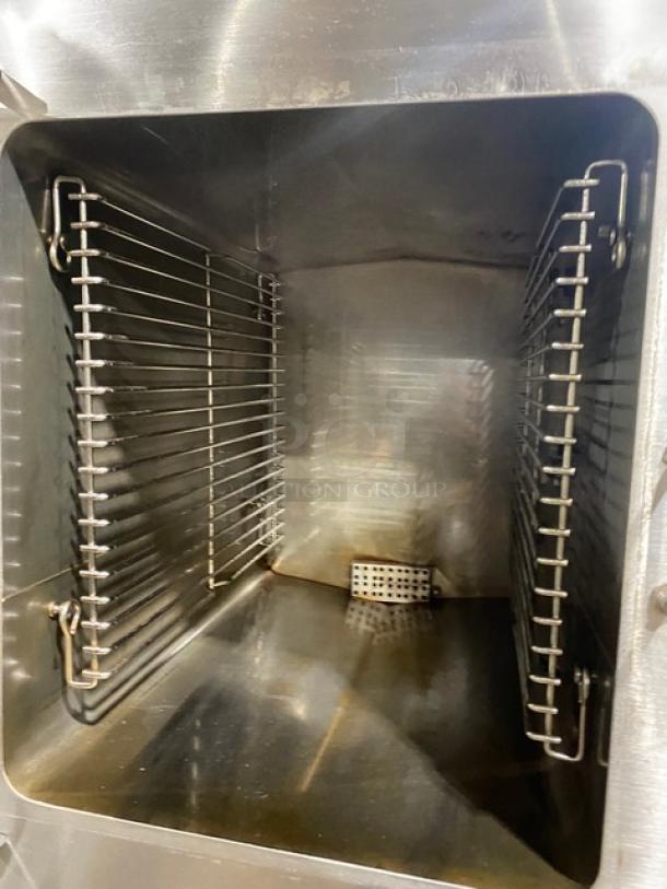 Stainless steel commercial oven interior, clean with visible racks and heating element, suitable for industrial use.