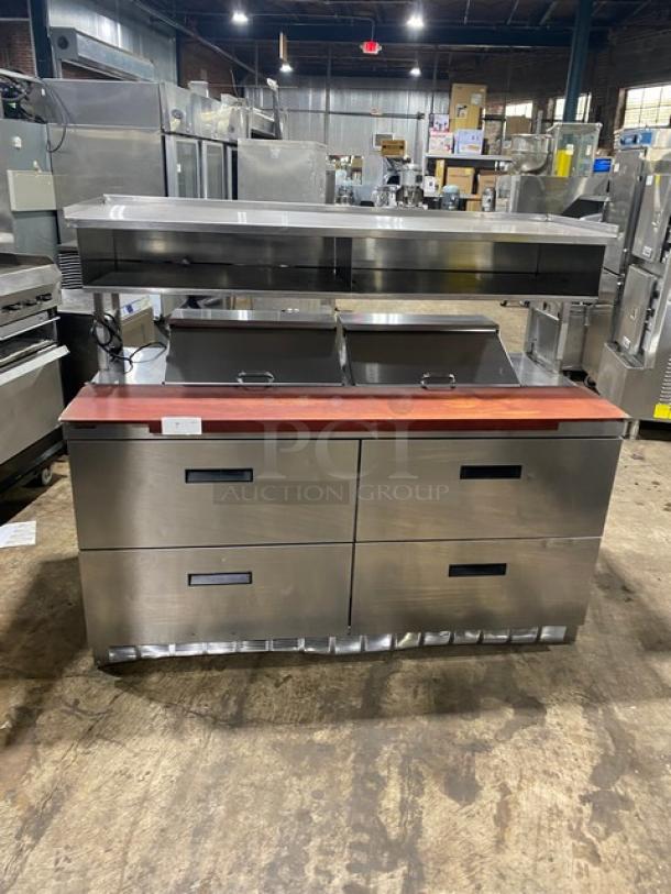 Stainless steel commercial kitchen workstation with red wooden top, four storage drawers, and overhead warming shelf in used condition.