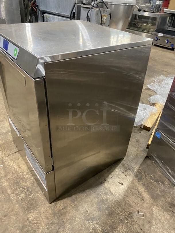Stainless steel commercial dishwasher, side view. Good condition, visible buttons and panel. Freestanding model for auction.