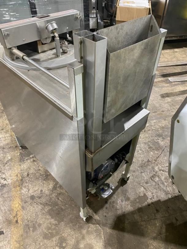 Stainless steel industrial meat slicer, well-used condition with signs of wear. Features a large blade and adjustable settings.