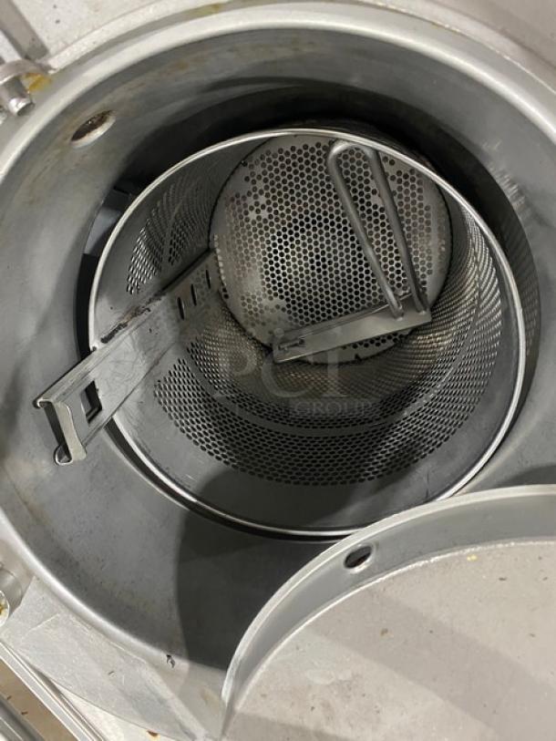 Industrial stainless steel perforated centrifuge basket in excellent condition, features robust construction and precision engineering.