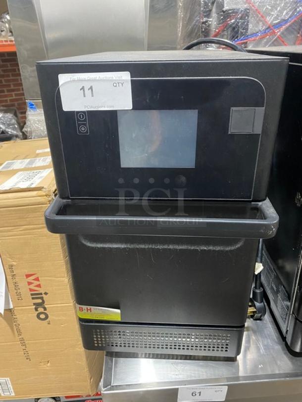 Commercial countertop ice dispenser with digital display, black finish, auction tag "11" visible, in used condition.