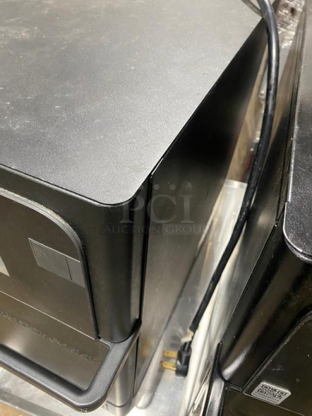 Black computer tower, minor scuffs, power cable attached, no visible brand or labels, suitable for refurbishment or parts.