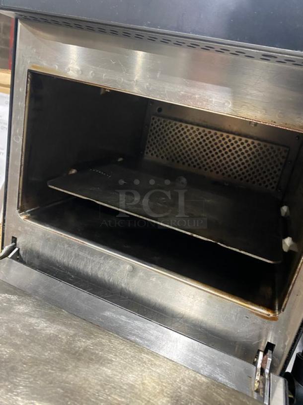 Commercial stainless steel countertop oven, open door, used condition, visible wear, suitable for restaurant equipment auctions.