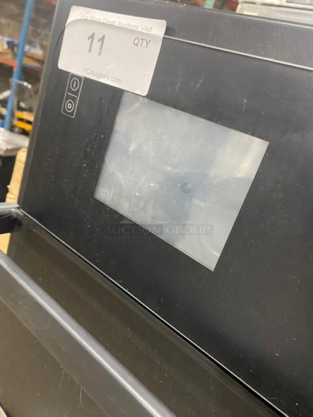 Black electronic device with screen; visible label reads "PCAuctions.com, QTY 11." Slight wear on surface.