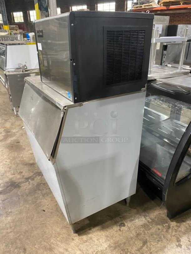 Commercial ice machine with stainless steel body, in good condition. Brand label visible. Ideal for restaurants.