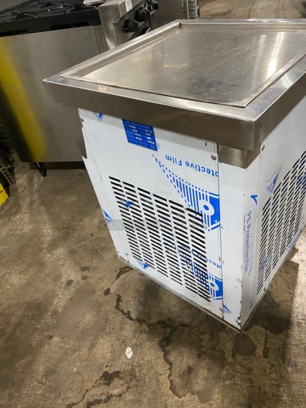 Commercial stainless steel refrigeration unit with protective film, top-grade condition. Ideal for professional kitchens.
