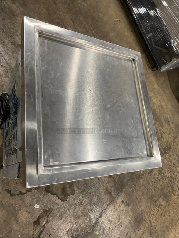 Stainless steel commercial food warming tray, scuffed surface, visible cord, sturdy construction. Ideal for restaurant use.