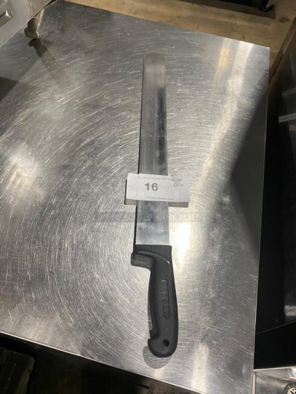 Large slicing knife with a black ergonomic handle, stainless steel blade, marked "16" for auction, on a metal surface.