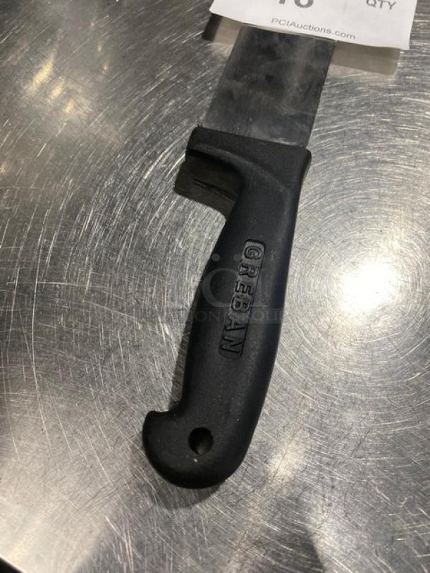Greban knife with black handle, partially visible blade, in good condition on metallic surface. Handle marked "GREBAN".
