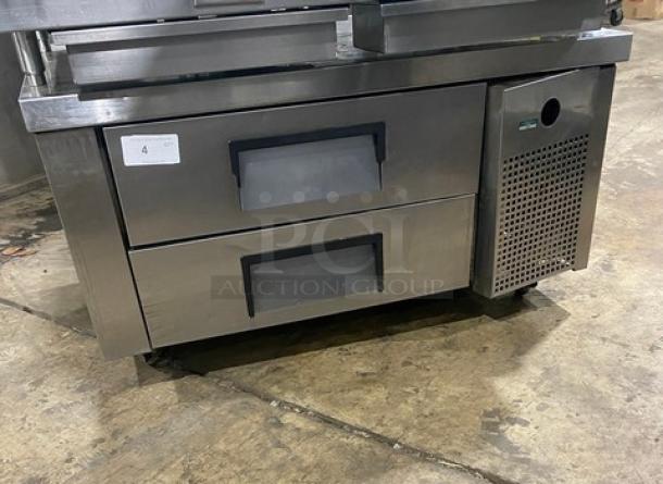Stainless steel commercial undercounter refrigerator with two drawers and ventilation panel, tag labeled "4", used condition.