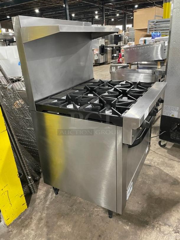 Commercial stainless steel six-burner gas range with oven, used condition, minor wear, suitable for restaurant kitchens.