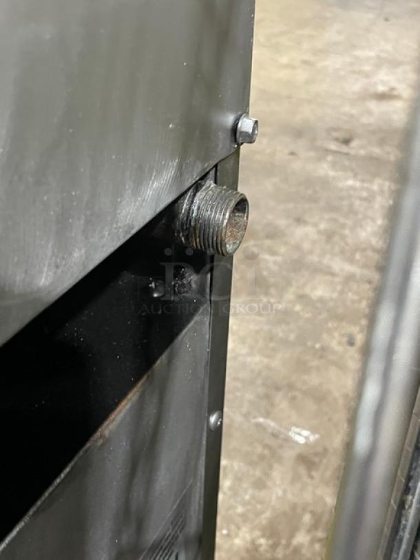 Metal machine component with a threaded pipe fitting. Condition shows signs of wear. No visible markings or labels.