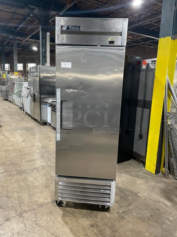 True TS-23 stainless steel commercial refrigerator, single door, on wheels, used condition with minor dents.