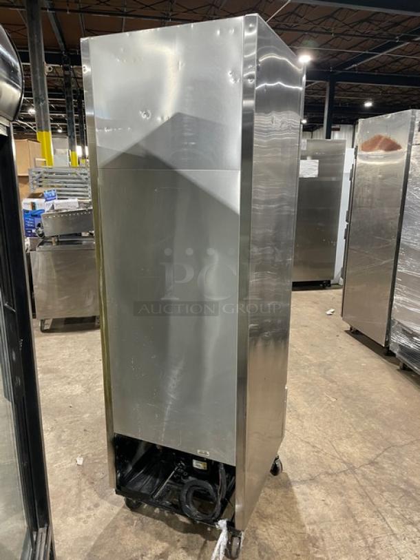 Commercial stainless steel freezer, upright design, with casters. Good condition, visible wear, no visible labels or markings.