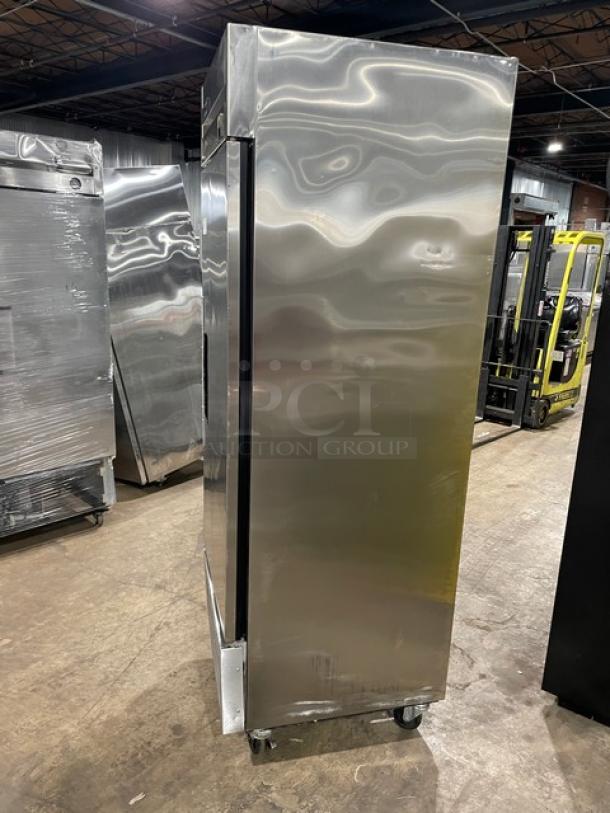 Stainless steel commercial refrigerator on wheels, in good condition, vertical orientation, suitable for industrial kitchens.