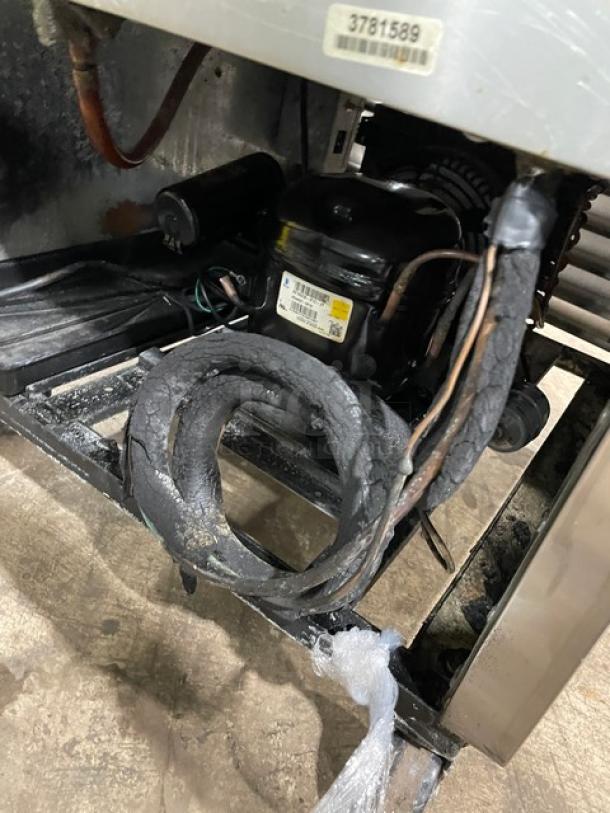 Industrial refrigeration unit compressor, showing wear and insulation damage. Visible label with partial serial number: 3781589.