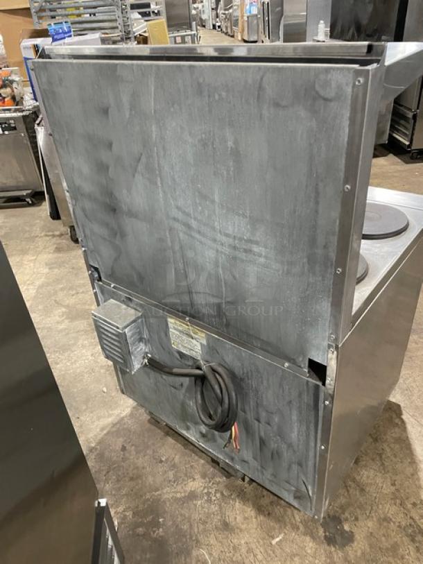 Commercial stainless steel kitchen appliance, likely a countertop griddle. Visible wear and electrical wiring.