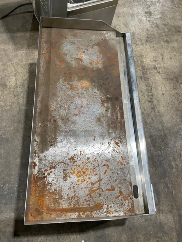 Industrial metal tray with rust patches, rectangular shape, showing wear. Condition indicates heavy use.