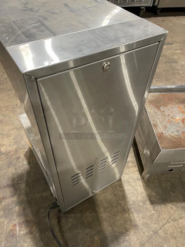 Stainless steel commercial warming cabinet, lockable door, vented bottom panel, used condition with visible wear, electrical cord attached.