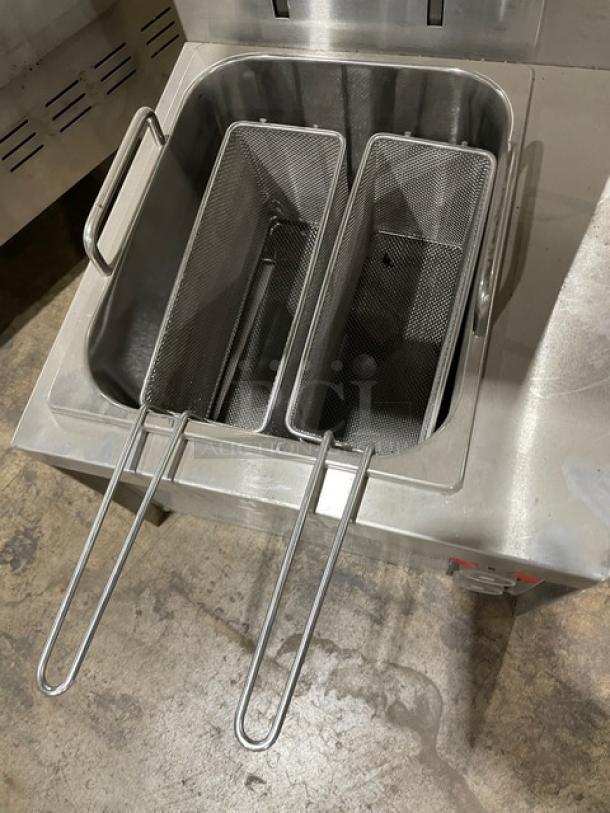 Commercial stainless steel deep fryer with dual baskets, sturdy handles, and a clean finish. Ideal for restaurant use.