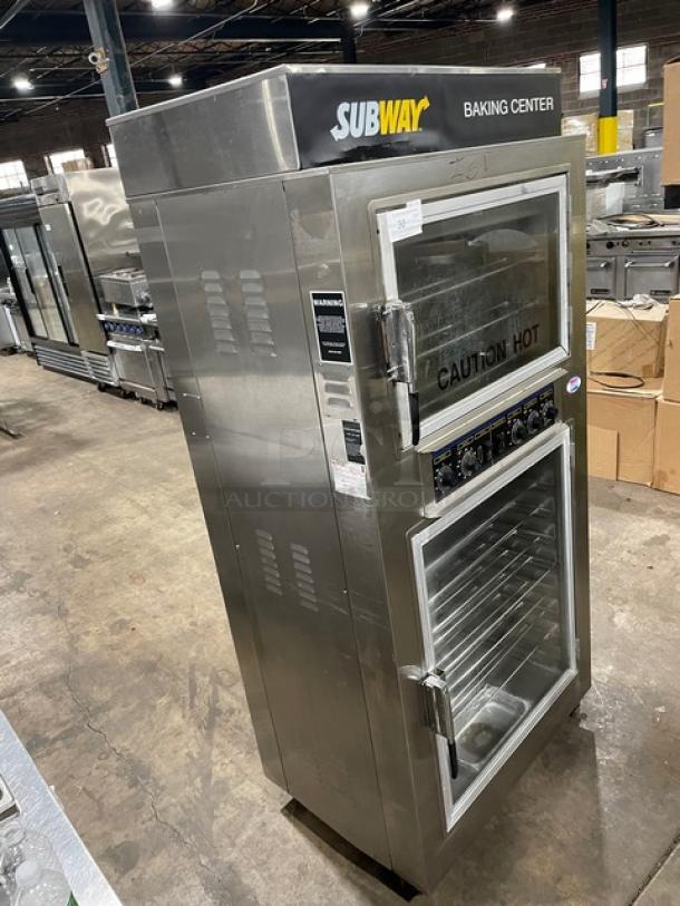 Industrial stainless steel baking center, labeled "SUBWAY," with "CAUTION HOT" on glass doors, visible warning labels.