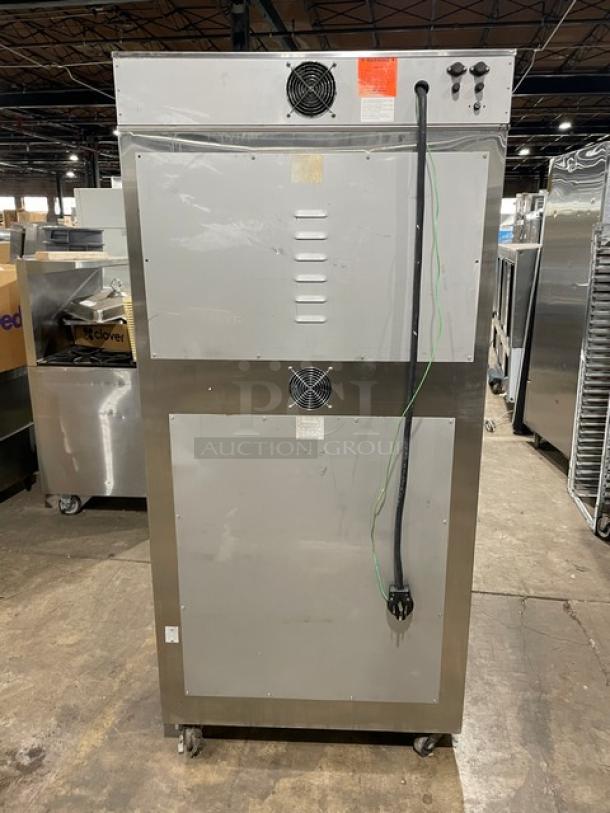 Commercial stainless steel cooling unit with dual fans, power cord, and control knobs. Mounted on casters for mobility. Appears in used condition.