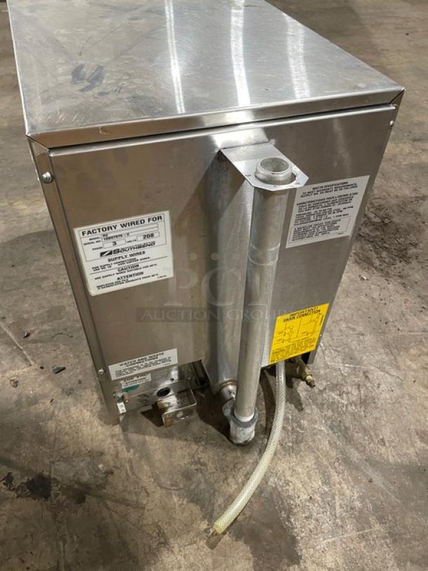 Stainless steel industrial dishwashing machine with visible wiring labels and hose attachments in good used condition.