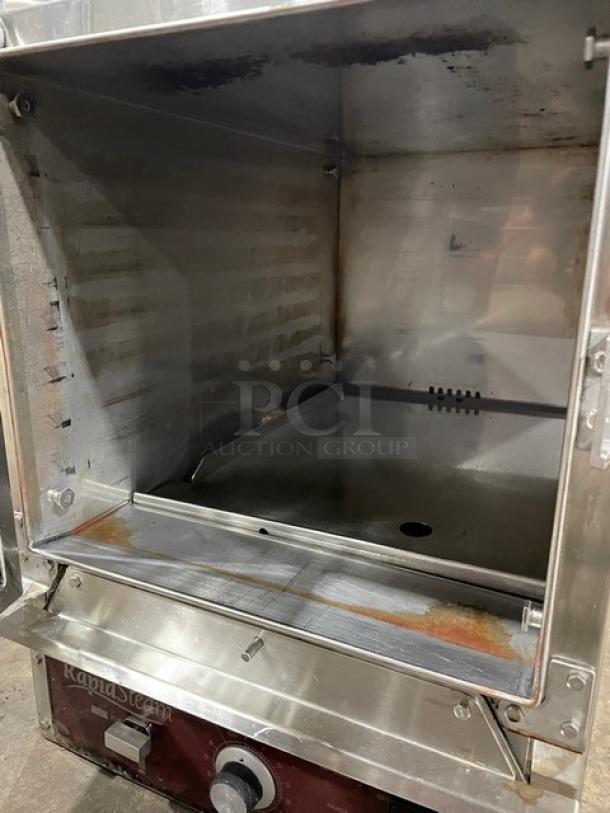 RapiD Steam commercial oven, stainless steel, visible wear and rust, operational dials, ideal for restaurant use.
