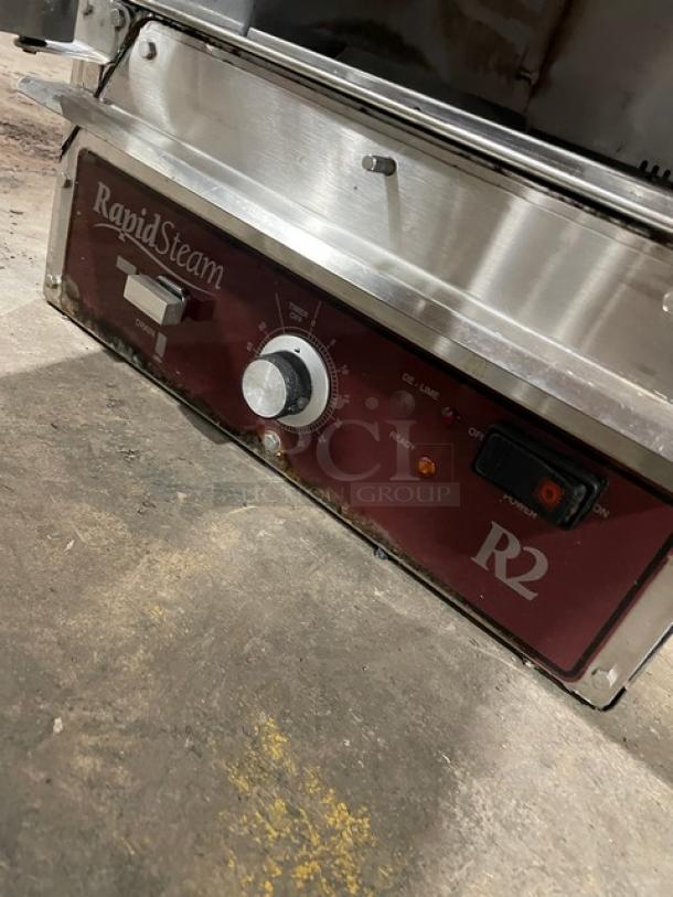 Commercial RapidSteam R2 machine with red control panel, knob, switch, and visible wear.