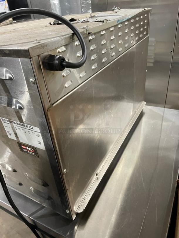 Commercial stainless steel griddle with ventilation hood, used condition, attached power cord; label indicates sanitary compliance.