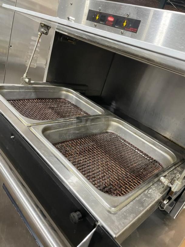 Commercial stainless steel fryer with two large baskets, showing signs of light use. Ideal for high-volume kitchens.