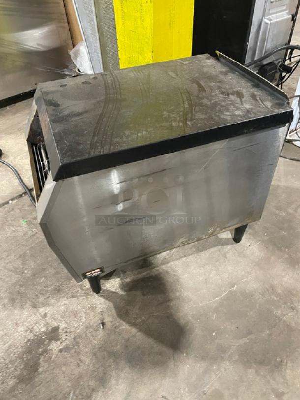 Stainless steel commercial oven; used condition with visible wear and marks; black trim; manufacturer tag partially visible.