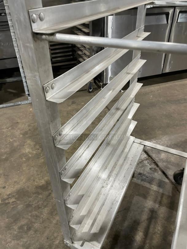 Metal baker's rack with multiple shelves, suitable for commercial use. Sturdy, good condition with wheels for mobility.