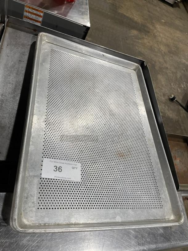 Perforated metal baking sheet in used condition, item tag indicates auction lot 36.