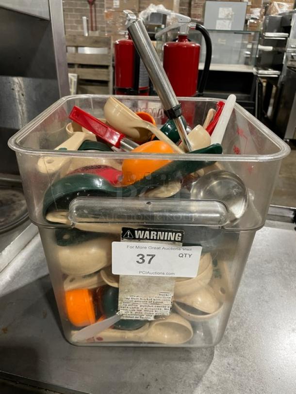 Container of assorted scoops, various colors and sizes, in used condition. Features visible label with auction lot number 37.