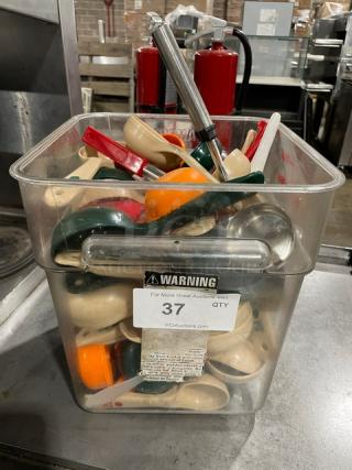 Container of assorted scoops, various colors and sizes, in used condition. Features visible label with auction lot number 37.