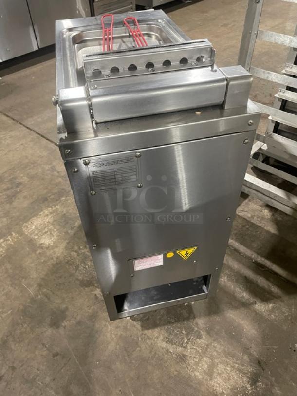 Commercial stainless steel deep fryer with double baskets, excellent condition. Safety and operation labels visible.