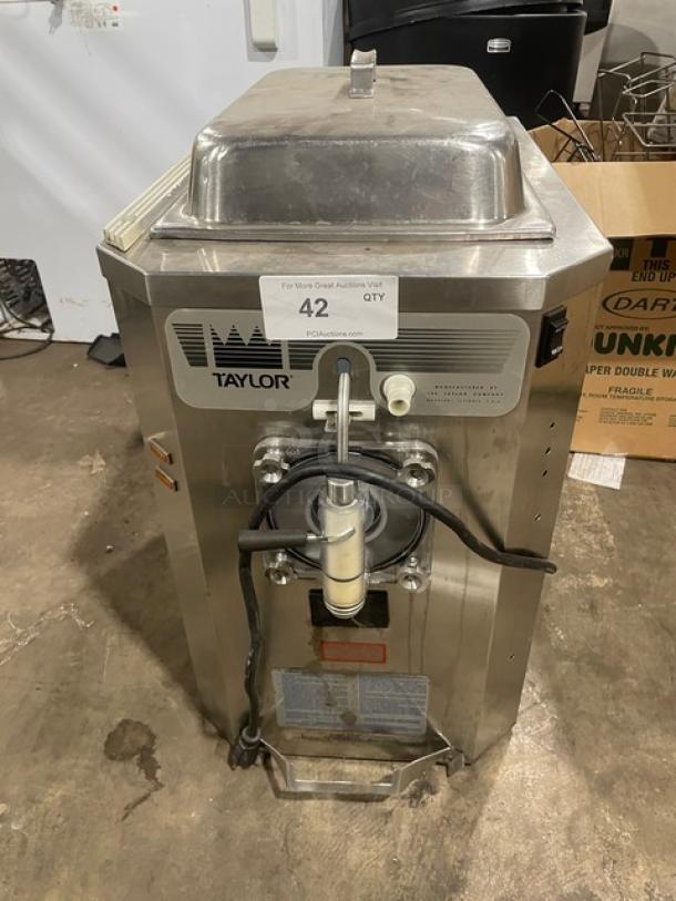 Taylor commercial ice cream machine, stainless steel, model 42 QTY, visible wear, tag indicates auction lot number.