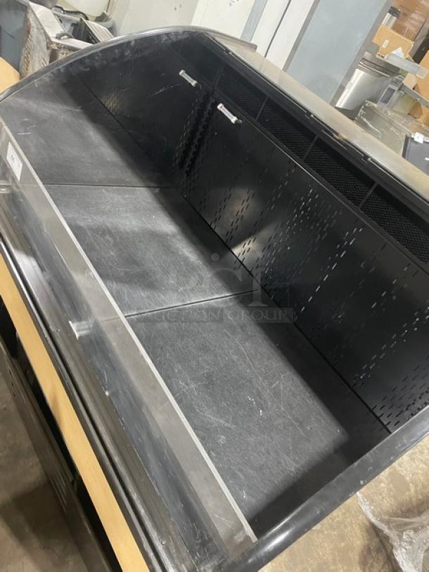 Commercial refrigerated display case, black exterior, glass front, used condition, minor surface scratches, vented back panel.