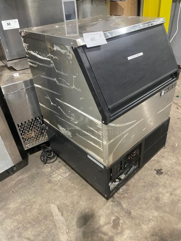 Commercial ice maker in used condition, stainless steel body with black lid. Marked with item number 46. Brand label visible.