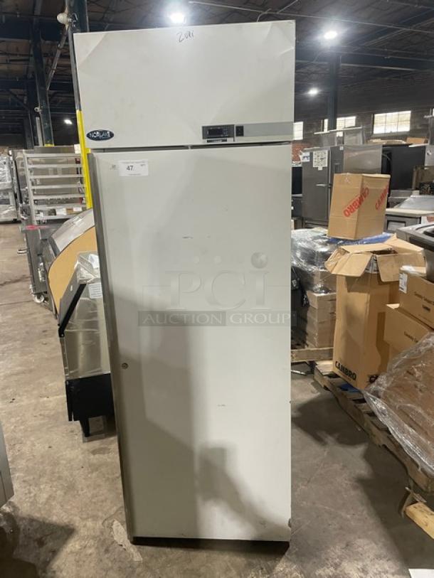 White commercial freezer with a Norlake logo, front digital control panel, and slight wear. Auction tag #47 attached.