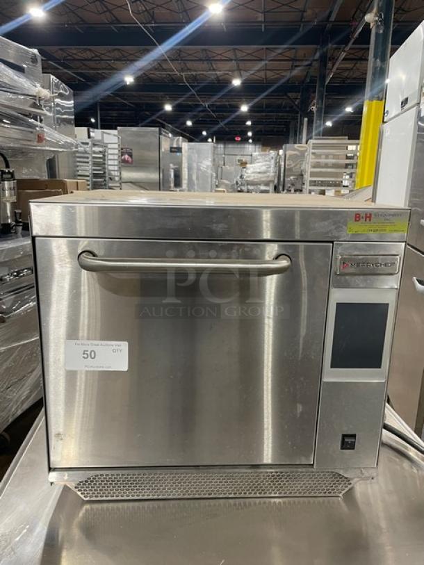 Stainless steel Merrychef oven in good condition, touchscreen display, visible model number. Auction label: B-H, QTY: 50.