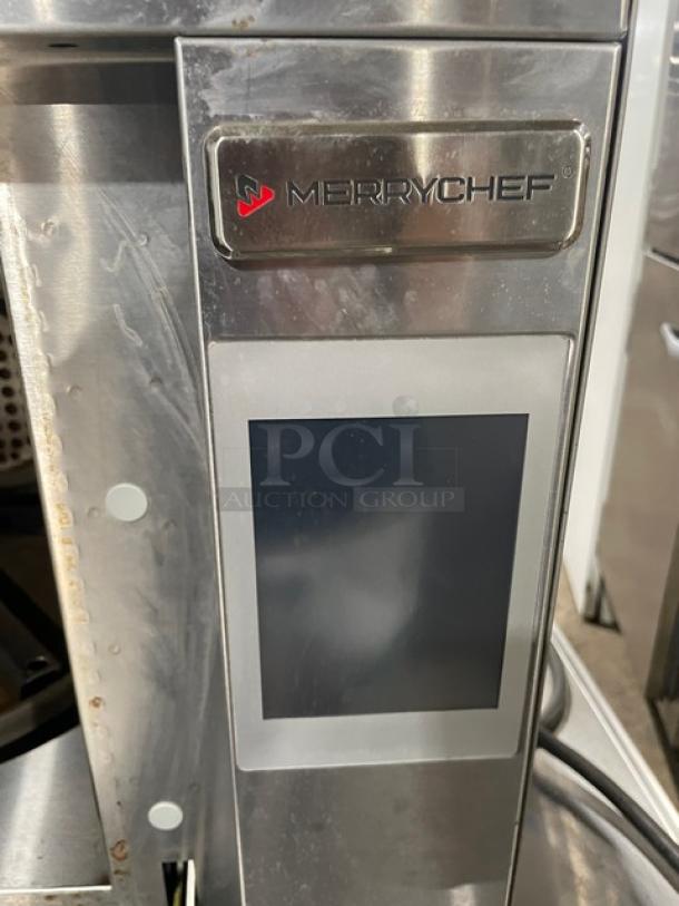 Merrychef commercial oven, stainless steel, touchscreen panel, used condition, model label visible, ideal for rapid cooking.