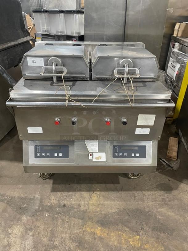 Commercial double-head panini press, stainless steel, digital controls, fair condition, with switches and safety latch.