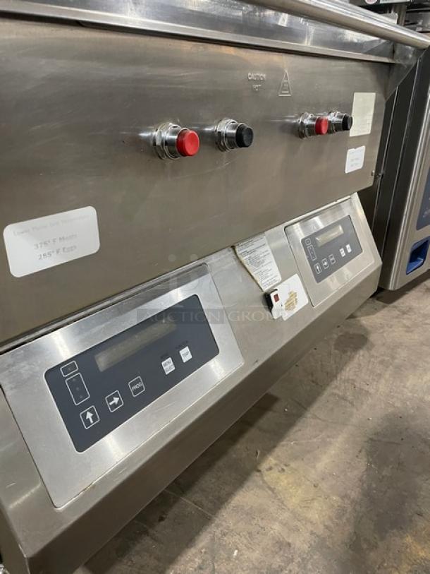 Commercial stainless steel kitchen equipment with control panels, buttons, and temperature labels. Good condition.