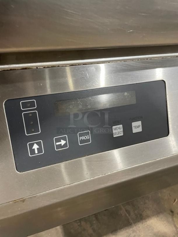 Stainless steel appliance control panel with buttons for program, menu select, and temperature settings.