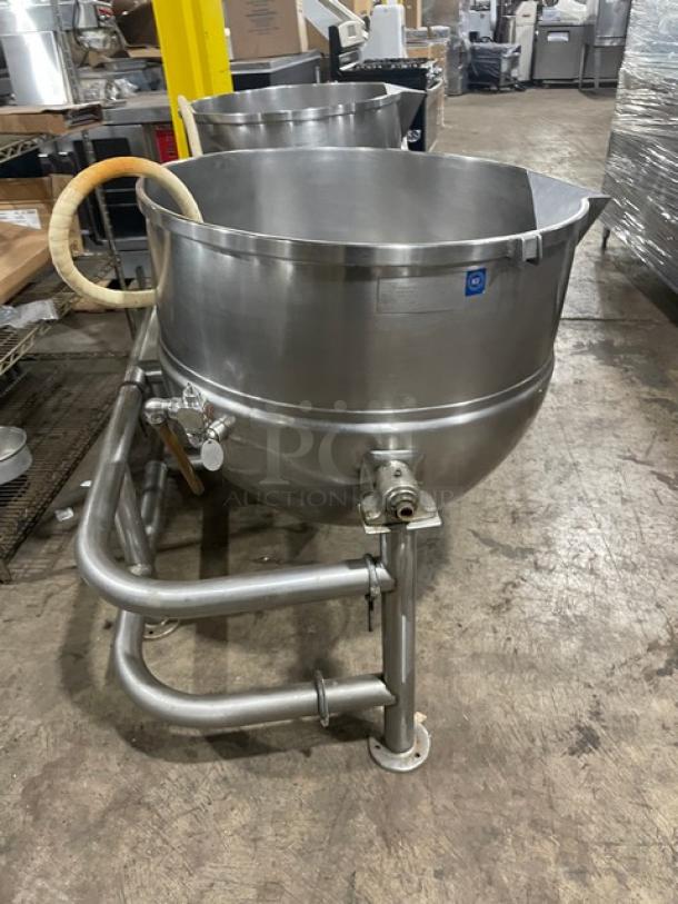Stainless steel commercial kettle with spout, handles, and sturdy base. Excellent condition; suitable for industrial kitchens.