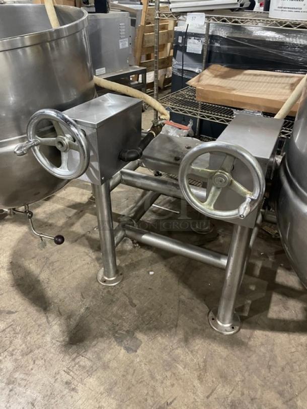 Stainless steel industrial mixer with crank wheels, used condition, visible surface marks, ideal for bulk food processing.